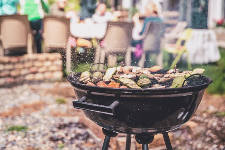 A grill outdoors with a collection of vegetables