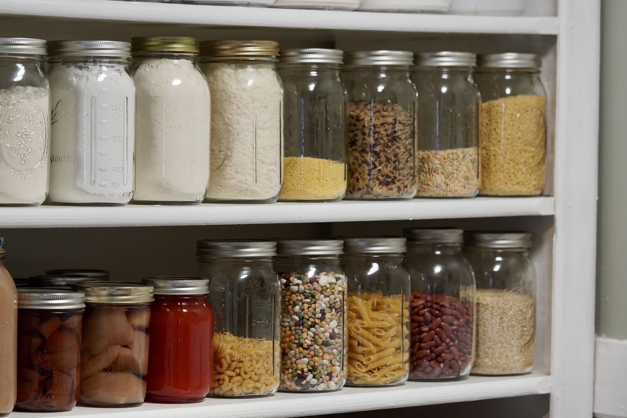 Flour, grains and dried beans stored in sealed glass jars to help keep pantry pests out of the kitchen.